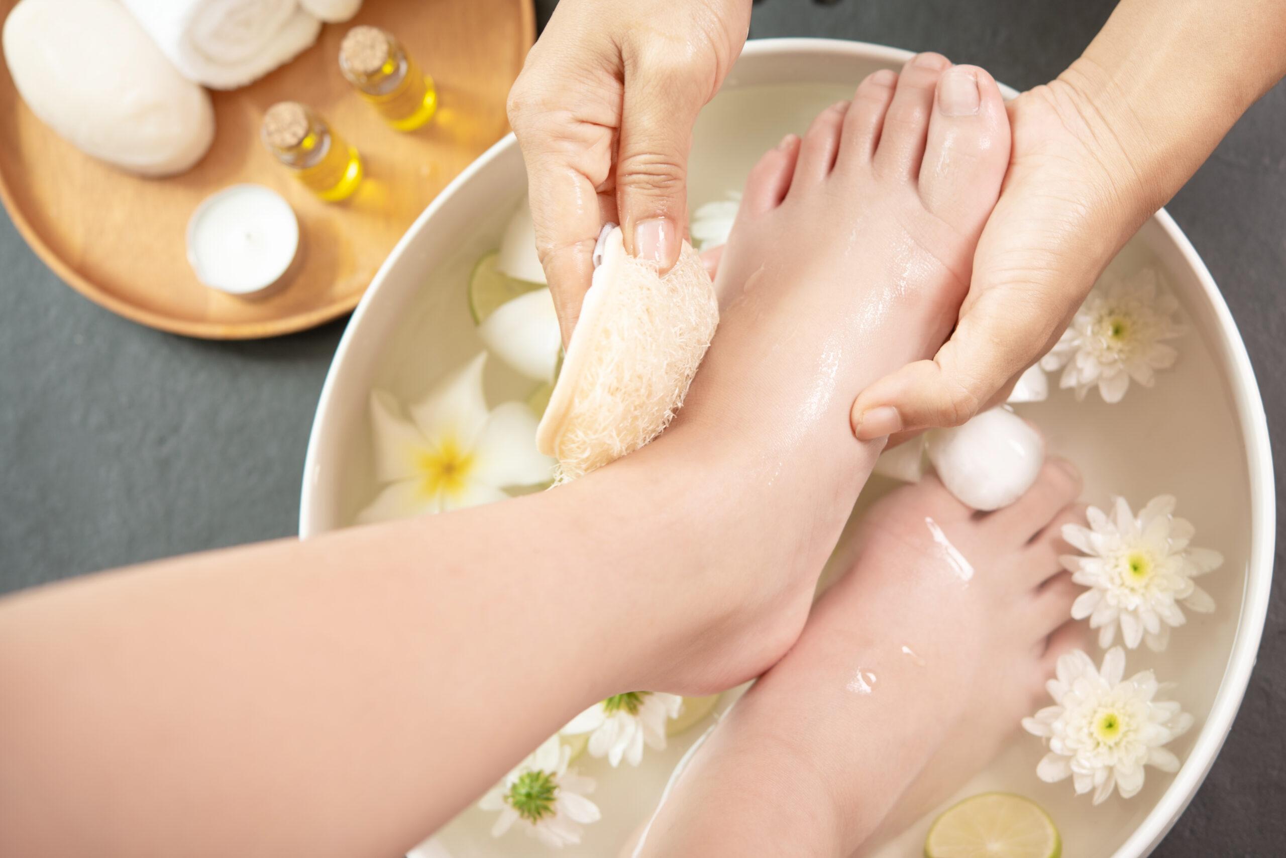 Feet being gently cleansed in a warm-water bowl during the Foot Ritual